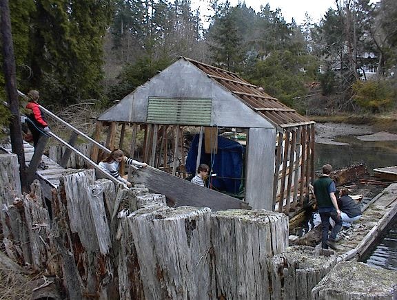 Boathouse structure being dismantled from the dock